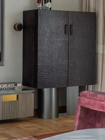 A custom bar cabinet designed for the Skyward Residence. Its textured wood finish and elevated form make it a functional sculpture in the corner of the room.