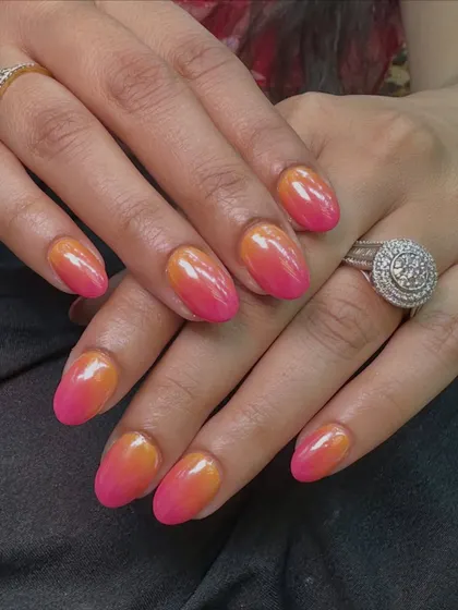 The chrome finish on these ombre nails catches the light beautifully, making the colors look even more vibrant and blended.