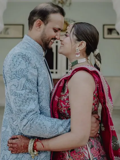 An intimate close-up of a couple, their faces close, sharing a happy and loving moment during their carnival-themed wedding event.
