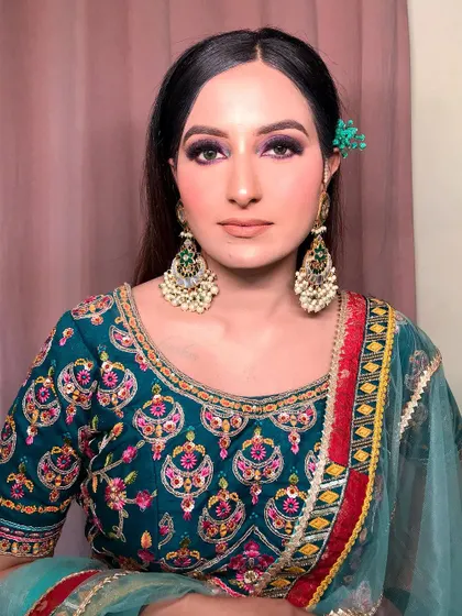 A final shot of this stunning look, showing how all the elements come together. The makeup is bold but not overpowering, enhancing her features beautifully.