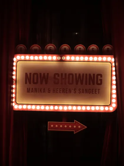 For a couple of movie lovers, we designed a Sangeet night with a cinematic premiere theme. This custom marquee sign, set against rich velvet drapes, welcomed guests to an evening of drama, dance, and old-Bollywood romance.