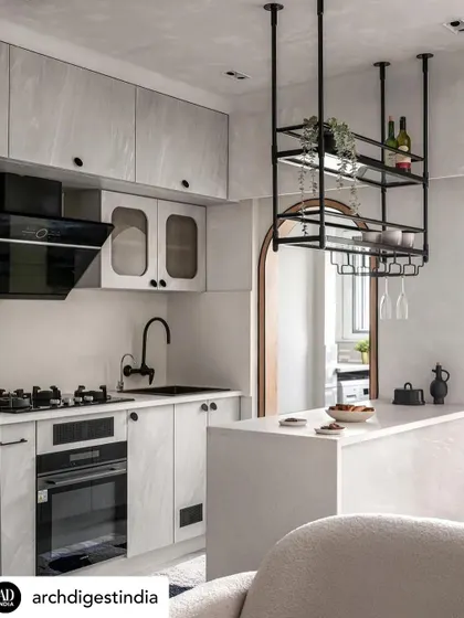 This view of the 'Unmei' kitchen shows how I use clean lines and a light color palette to make a small space feel open and airy. The suspended bar unit adds storage without taking up floor space, maintaining a minimalist feel.