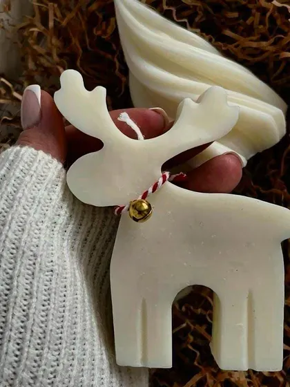 This adorable reindeer-shaped candle, complete with a little bell, adds a touch of festive charm to your holiday decor. It's made with high-quality soy wax.