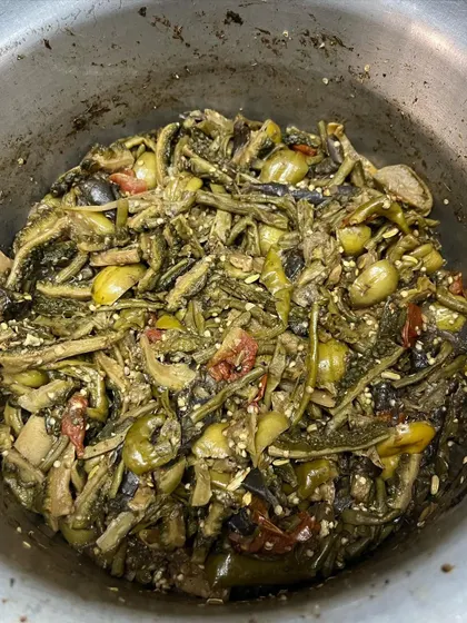 A large pot of 'Rusep' being prepared in our kitchen. Even though we are known for our pork, we love our vegetables and are excited to share this authentic wild veggie dish with you.