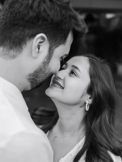 A black and white close-up capturing the look of love between the couple. The tight framing makes this moment feel incredibly personal and intimate.