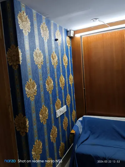 Another view of the blue and gold wallpaper in the office space.