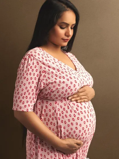 A simple, heartfelt portrait focusing on the mom-to-be's connection with her baby bump.