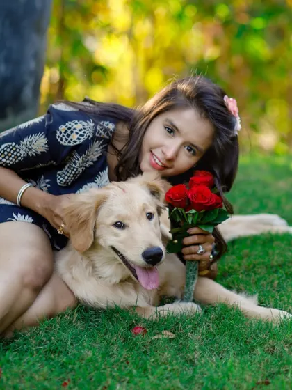 A loving cuddle between a pet parent and her Golden Retriever during their outdoor Valentine's session. The beautiful natural light adds a warm, romantic feel to the portrait.