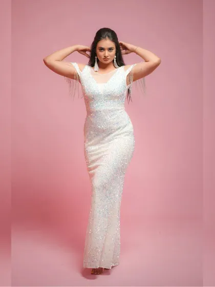 This white sequin bodycon dress is all about glamour. The tassel details on the cold-shoulder sleeves add a fun, flirty touch.