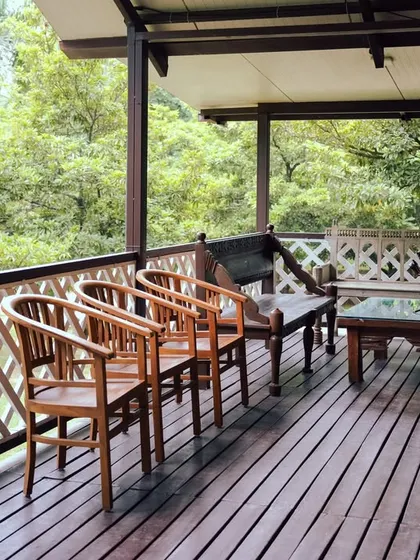 The spacious wooden deck of our cabins, furnished for you to sit back, relax, and soak in the surrounding forest views.