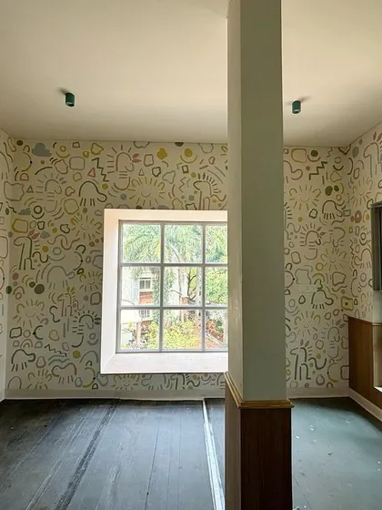 The completed doodle room, with whimsical patterns covering every wall. The design was done free-hand to give it a spontaneous and playful feel.