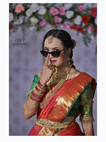 A fun and modern bridal portrait, where the bride playfully poses with sunglasses during her engagement ceremony.