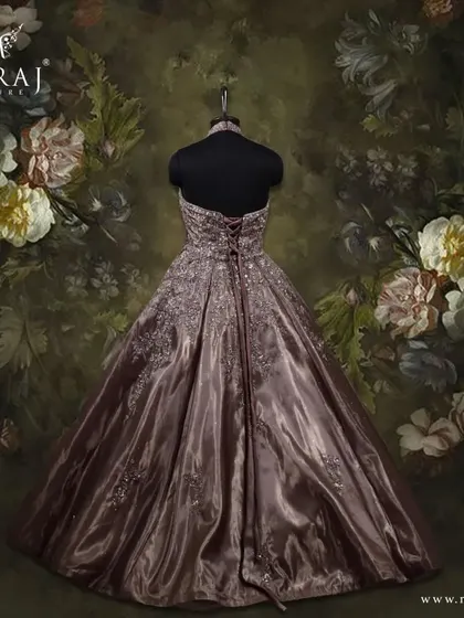 The back view of the halter neck brown gown, crafted from organza tissue and enriched with beautiful embellishments.
