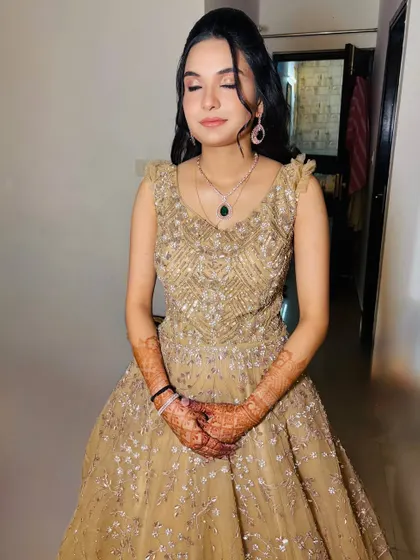 A close-up of the makeup for the golden gown look, featuring soft brown eyeshadow and a winged liner.