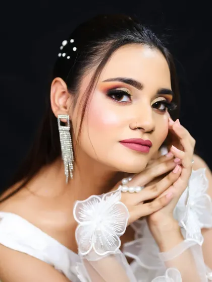 A close-up on the hands and face, showing how the makeup and accessories create a cohesive and polished style.