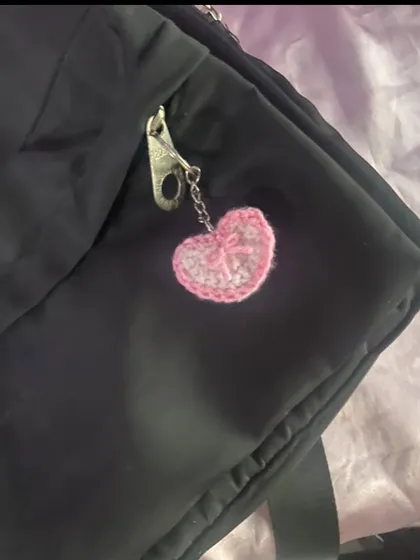 This is my pink crochet heart charm with a little bow detail. It's perfect for adding a soft, girly touch to your keys or bag.