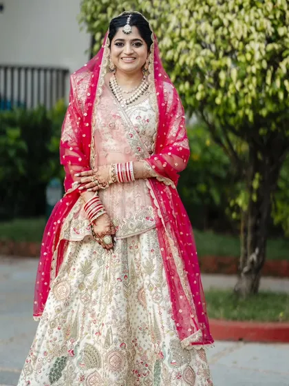 A full shot of the bride, looking absolutely radiant. The entire look, from head to toe, is a perfect example of classic bridal beauty.