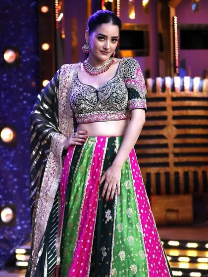 Embrace the allure of tradition with a modern twist in this vibrant blossom lehenga, featuring a multi-color skirt and an embroidered green blouse.