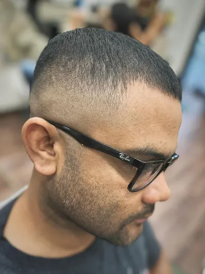 A detailed shot of the skin fade. The gradient is smooth and even, which is the key to a flawless fade. This is a skill I focus on in my barbering masterclasses.