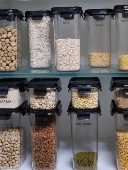 A look at a pantry cabinet we organized. Using stackable, clear containers for grains and pulses maximizes space and keeps everything visible.