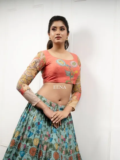 Discover the beauty of traditional craftsmanship with this stunning Pen Kalamkari lehenga. The piece is meticulously hand-painted by my artisans, with a story unfolding on the blouse sleeves and a beautiful floral pattern on the skirt and dupatta.