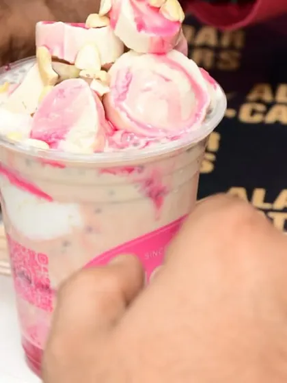 A close-up of the delicious Falooda from our dessert partner, Hajoori's, loaded with ice cream, nuts, and sabja seeds.