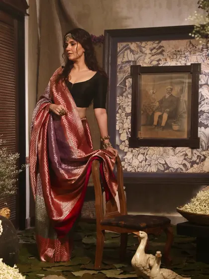 A moody and atmospheric shot for Soho Begum, featuring a model in a shimmering silk saree against a dark, artistic backdrop.