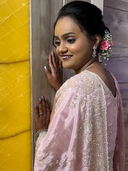My reception bride Shivani, looking radiant in a soft pink saree. The makeup is dewy and fresh, with a simple yet elegant updo.
