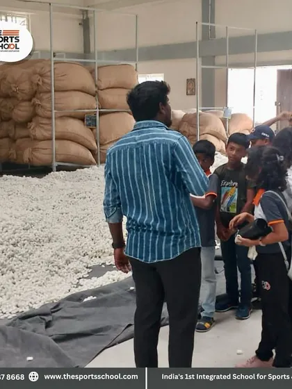 A guide explains the process of silk production, showing the students the raw silk cocoons.
