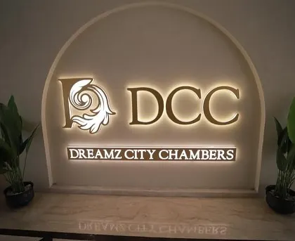 The entrance and branding are key to a commercial space's identity. For the Dreamz City Chambers project, we designed this elegant backlit logo signage. It creates a strong first impression and sets a professional tone for the entire building.