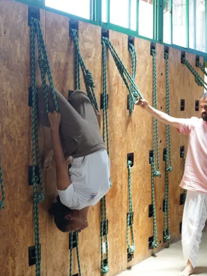 Here I am adjusting a student in a supported inversion on the Yoga Kurunta. This hands-on guidance ensures safety and helps the student experience the full therapeutic benefits of the pose.