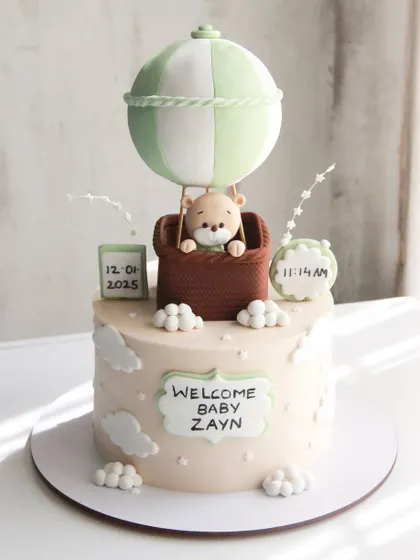 Up, up, and away! Welcoming baby Zayn with this dreamy hot air balloon cake, personalized with his birth date and time.