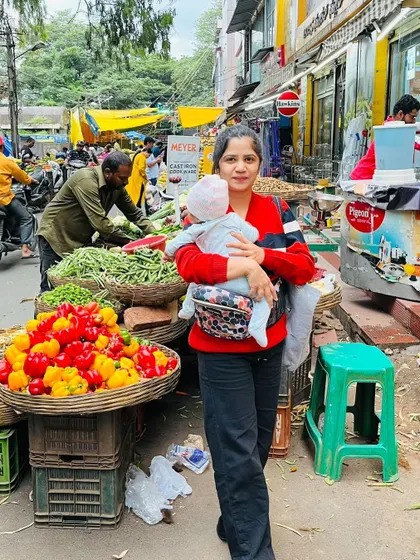 A full-length shot at the market, showing how I manage daily chores with my baby. This is the reality of motherhood.
