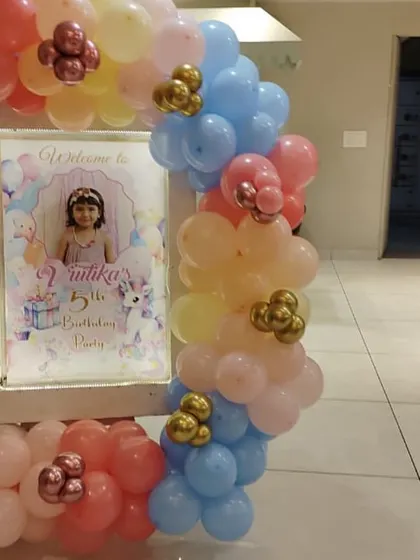 I can create personalized welcome signs for your party entrance. This one for a 5th birthday features a photo of the birthday girl and is framed with a beautiful pastel balloon garland.