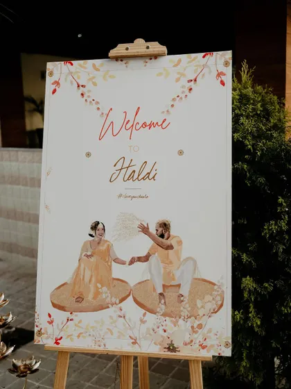 Another view of the personalized caricature welcome board, a unique and charming way to welcome guests to the Haldi celebration.