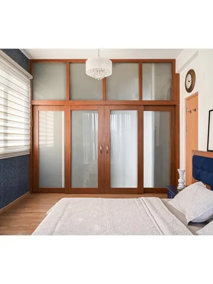 A full view of the sliding wooden doors that lead to the walk-in closet.