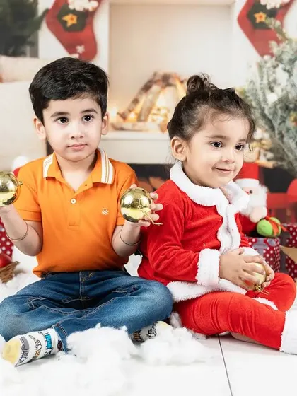 Siblings enjoying the festive spirit together in a beautifully decorated Christmas scene.