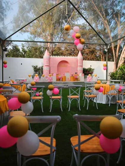 A princess-themed birthday party at The Backyard, with a focus on the guest seating. The pink and gold balloons tied to the chairs add a fun and festive touch.
