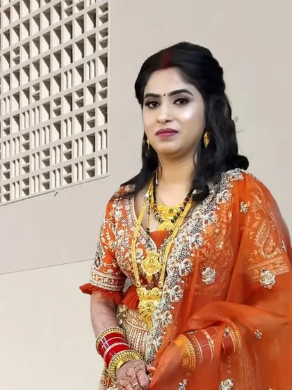 A beautiful reception look for a bride. The makeup is soft and elegant, paired with a half-up hairstyle and traditional jewelry.