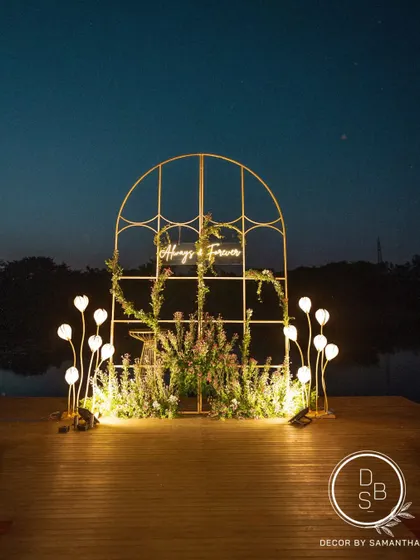 The reception backdrop set against the still waters of a natural lake at sunset. The changing colors of the sky created the most beautiful, evolving canvas for the "Always & Forever" sign.