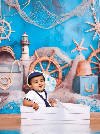 A wide shot of the complete nautical setup. I take care of every detail, from the sandy floor to the starfish and ship's wheels, to create a fully immersive experience.