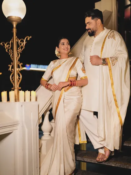 A stunning full-length shot of the power couple in their custom-designed festive wear, looking elegant and perfectly in sync.