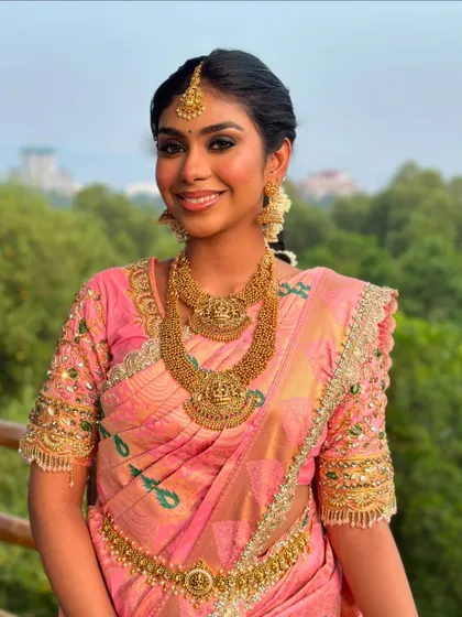 A front-facing portrait, her smile is radiant and her makeup is flawless.