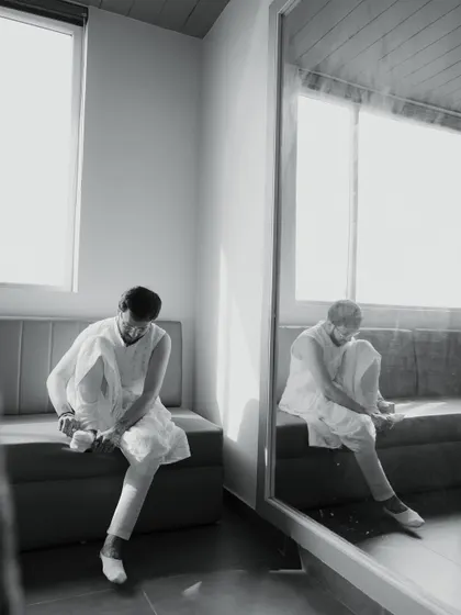 A quiet, reflective moment of the groom getting ready. This black and white shot captures the calm before the beautiful chaos of the wedding.
