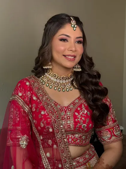 A final shot of this red bridal look, capturing the perfect harmony of the makeup, hair, and outfit. The warm tones and soft shimmer create a truly timeless appeal.