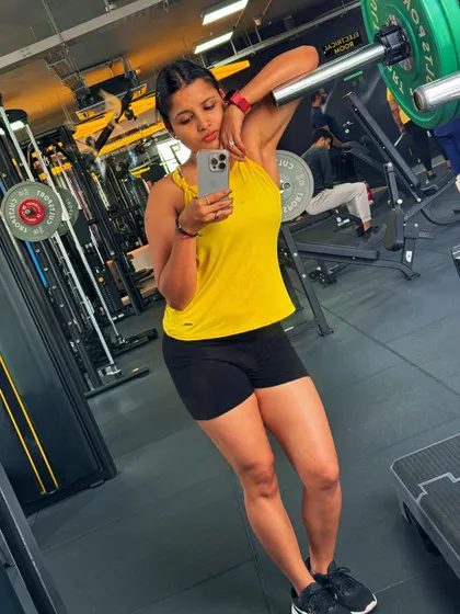 Leaning against a barbell rack after a tough workout. This is the satisfying feeling of giving your all during a training session.