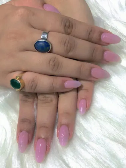 A still photo of the elegant nude pink almond nails.