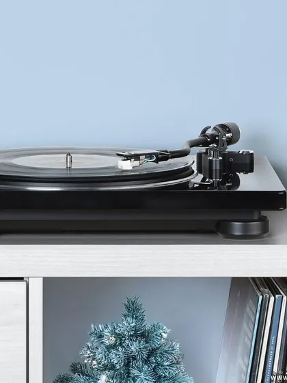 A Denon turntable setup, elegantly placed for the holiday season. We believe in creating audio experiences that become part of your home's ambiance, and a classic vinyl setup offers both superior sound and timeless style.