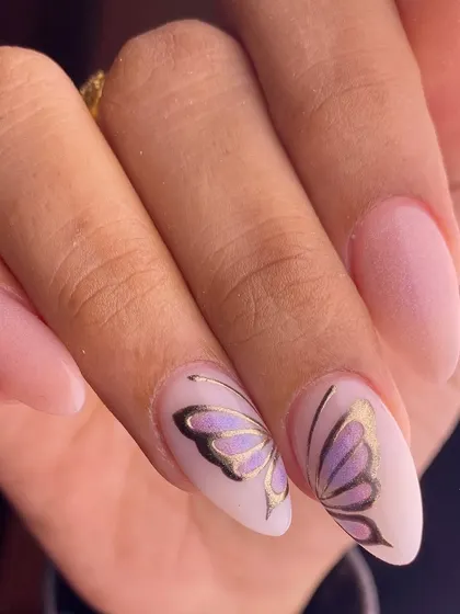 Delicate butterfly wings hand-painted across two nails, giving the illusion of a single butterfly. This design, set against a soft matte pink base, highlights my precision in creating elegant and artistic nail art.