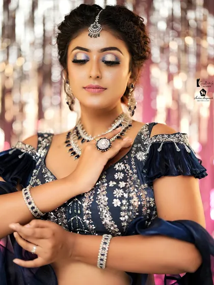 A serene pose that highlights the beautiful blend of the eyeshadow and the sparkle of the jewelry.